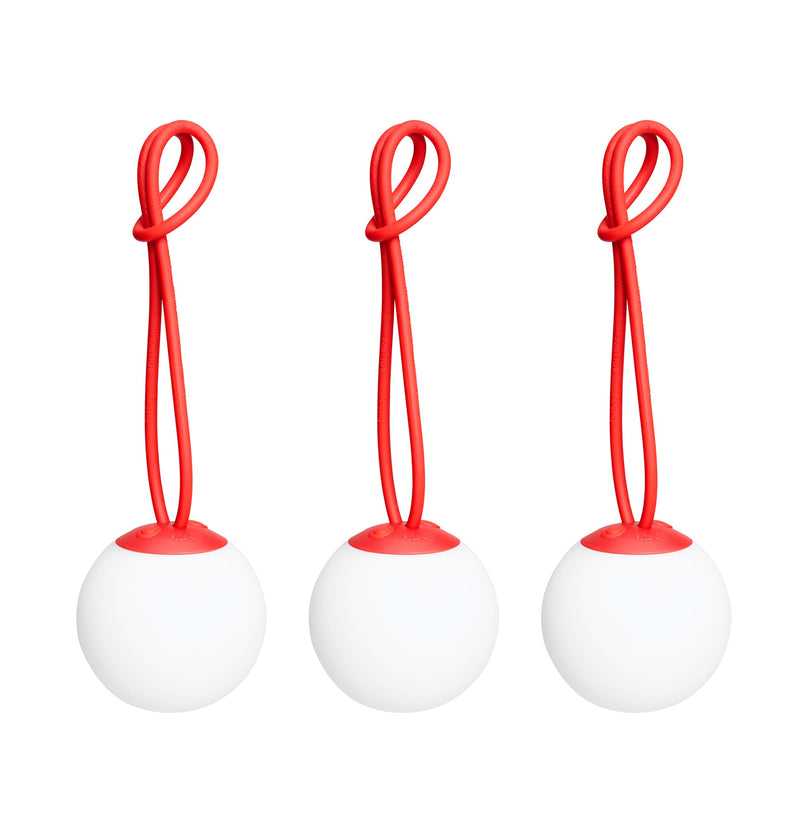 Bolleke Mini set of 3, with red loop, brings warm, portable light to indoor and outdoor spaces.